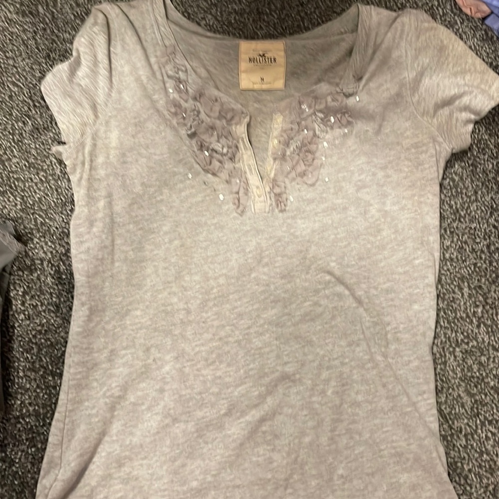 Hollister t-shirt with lace flowers and sequins around the neck. Size medium